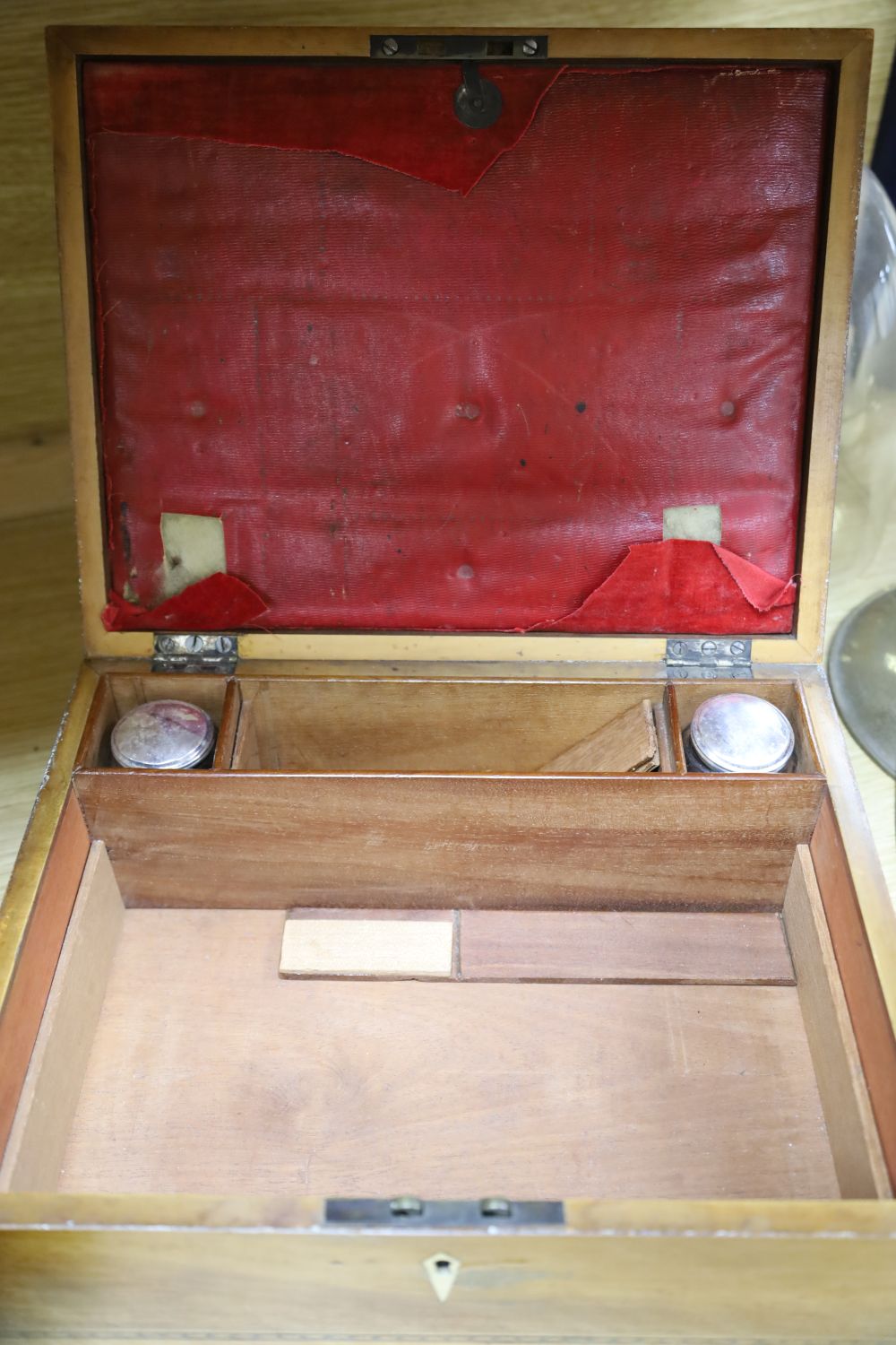 An early 19th century mahogany sarcophagus shape tea caddy with gilt metal mounts, 32cm, and a 19th century writing / work box, width 3